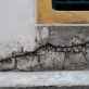 cracks on wall near window in urban area photo 1